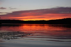 deep pink sunset over lake