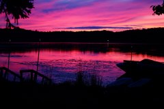 deep pink and purple sunset over lake